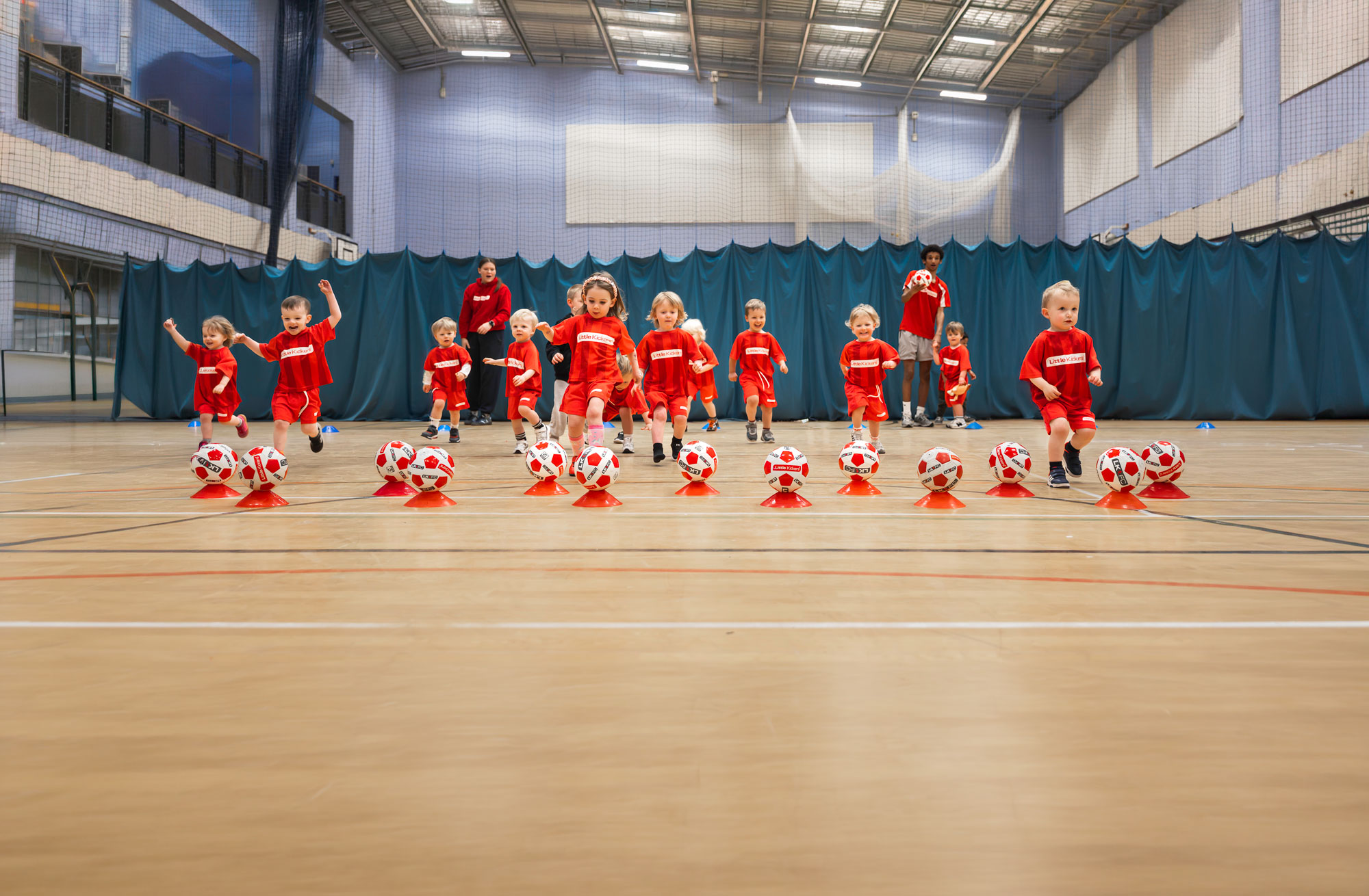 Maidstone Pioneers players running to kick footballs